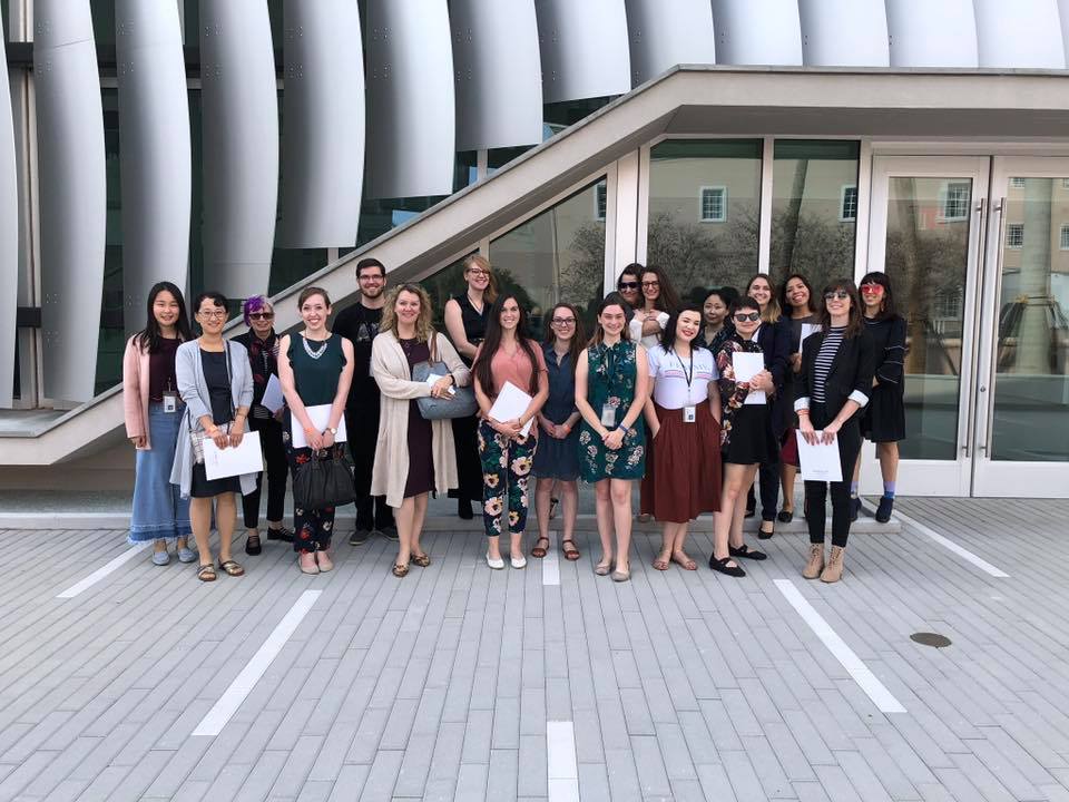 a group of people standing in front of a building