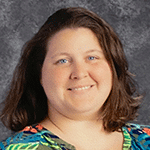 there is a woman that is posing for a picture in front of a black background